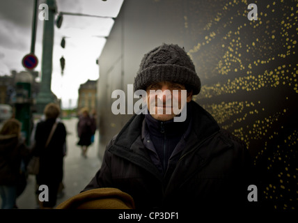 Urban poverty, A Romanian, in place of Vendome in Paris Stock Photo