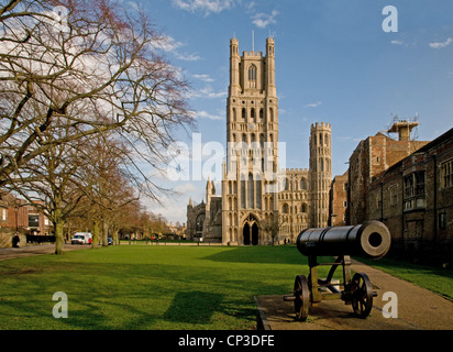 The west Tower and entrance to Ely Cathedral Cambridgeshire England with Russian cannon on Palace Green Stock Photo
