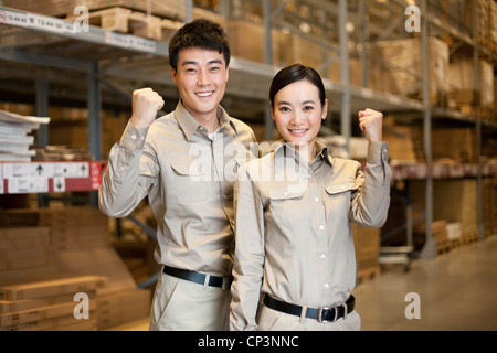 Male and female Chinese warehouse workers Stock Photo