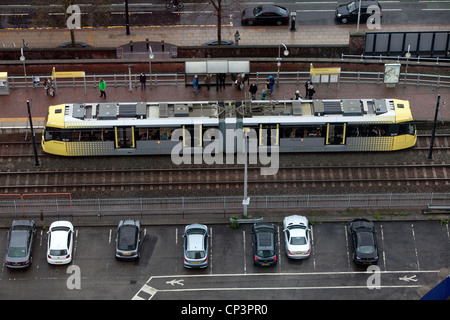 Aerial view of a Metrolink tram at a tram stop in Manchester City Centre . Stock Photo