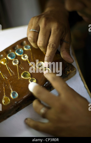 A worker making fine jewelery at the Gem Palace, Jaipur's foremost jewelers, Jaipur, India Stock Photo