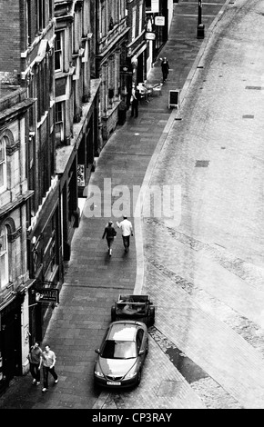 Overhead shot of two people walking along street, Newcastle City Centre Stock Photo