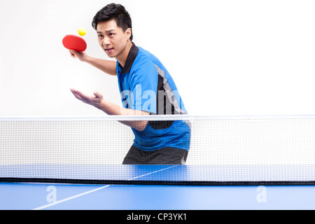 Table tennis player serving Stock Photo