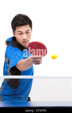 Table tennis player hitting ball Stock Photo