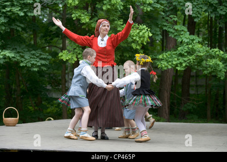 Latvia - Folk festival. Children in traditional costume as they perform a folk dance Stock Photo