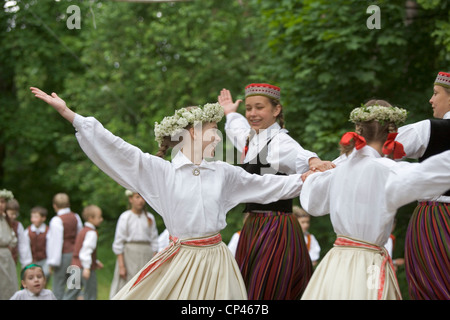 Latvia - Folk festival. Girls in traditional costume as they perform a folk dance Stock Photo