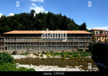 Piedmont Biella. One of buildings of former mill Maurizio Sella, industrial archaeological complex (XVII-XIX century) on banks Stock Photo