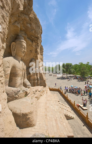 Tourists visiting the Ratnasambhava Bodhisattva Cave (Cave No. 19) at the Yungang Grottoes - the second tallest at 16.8 mtrs. Stock Photo