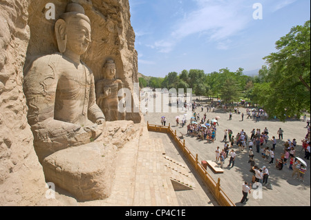 Tourists visiting the Ratnasambhava Bodhisattva Cave (Cave No. 19) at the Yungang Grottoes - the second tallest at 16.8 mtrs. Stock Photo