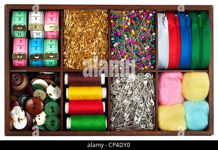 Assortment of different tailoring materials (tape-measure,safety pins,needles,zippers,buttons,spivels,threads and cottons) in vi Stock Photo