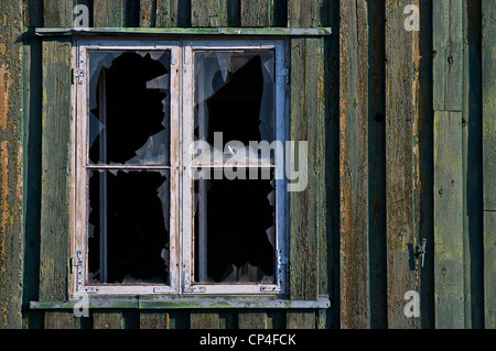 Greenland - Qaasuitsup Kommunia - Disko Island - Dundas. Broken window of a house in the abandoned village. Stock Photo
