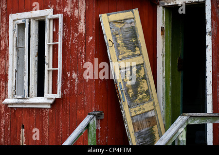 Greenland - West Coast - Qunlissat. Abandoned mining town. Entrance of a house with broken door and windows. Stock Photo