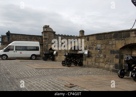 Van inside Edinburgh Castle with cannons lined up at the wall of the castle. These are located at the roof of Edinburgh Castle. Stock Photo