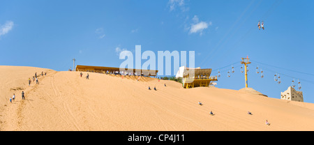 Tourists at the Shapatou Theme Park enjoy sand boarding and the zip wire rides. Stock Photo