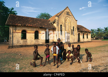 Ivory Coast - Grand-Lahou. Children outside a church in the colonial era. Stock Photo