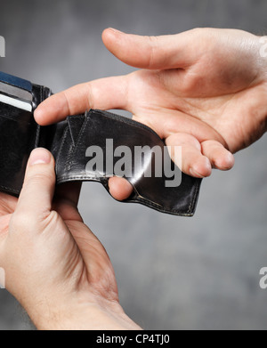 Man showing a hole in the coin pocket of his wallet. Stock Photo