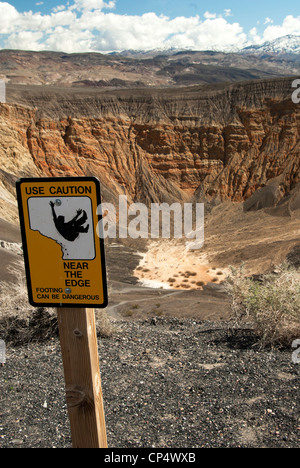 Caution sign at edge of Ubehebe Crater hiking trail Stock Photo