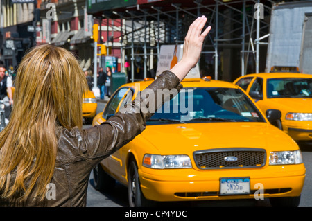 woman hailing  New York City taxi Stock Photo