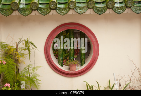 a round barred window in wall background Stock Photo