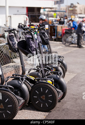 Segway personal transporters parked on fence - San Francisco, California USA Stock Photo