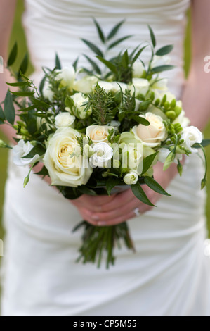 bride holding a bouquet of flowers with roses Stock Photo
