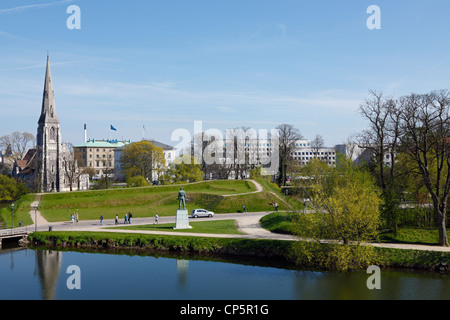 View from the ramparts of the citadel Kastellet over the moat to the English Church, St. Alban's, and the domicile of Maersk. Stock Photo