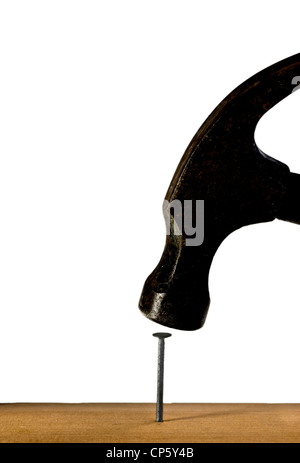 Hammer hitting a nail into some wood. Stock Photo