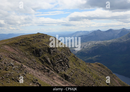 Slioch southern top and trig point from the north top. Beinn Eighe can be seen beyond on right Stock Photo