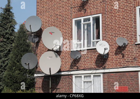 A large number of television satellite dishes on an apartment block (Burne Jones House) in Fulham, London, UK. Stock Photo