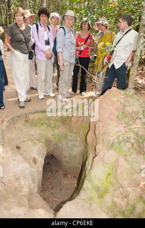 Tourists beside a tunnel entrance at Ben Dinh, Cu Chi, near Ho Chi Minh City, (Saigon), Vietnam Stock Photo