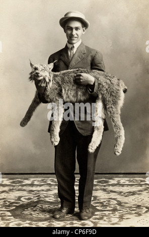 Young Man with Enormous Pet Cat Stock Photo