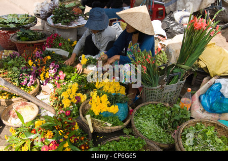 Horizontal close up of a traditional flower stall at the daily market in Hoi An Old Town. Stock Photo