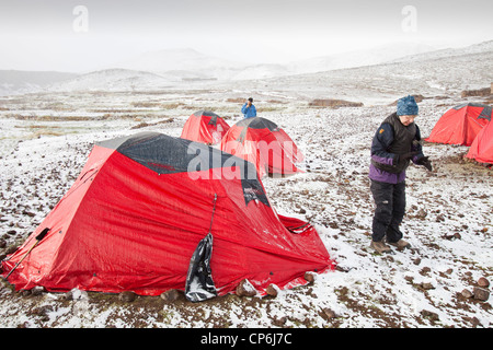 Trekkers camping in the Anti Atlas mountains of Morocco in fresh snow. Stock Photo