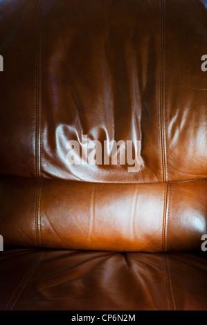 Close up photograph of sunlight on a fine leather recliner seat Stock Photo