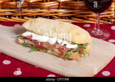 Tasty sandwich with parma ham, mozzarella and arugula Stock Photo