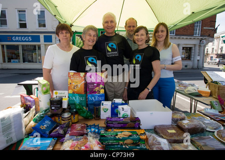 Volunteers promoting fair trade products on a market stall in Devizes, Wiltshire Stock Photo