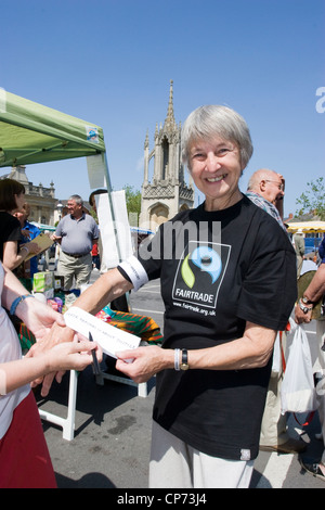 Volunteers promoting fair trade products on a market stall in Devizes, Wiltshire Stock Photo