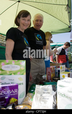 Volunteers promoting fair trade products on a market stall in Devizes, Wiltshire Stock Photo