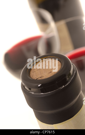 Bottle of red wine with black foil cut off and two wine glasses at background. (Shallow DOF) Stock Photo