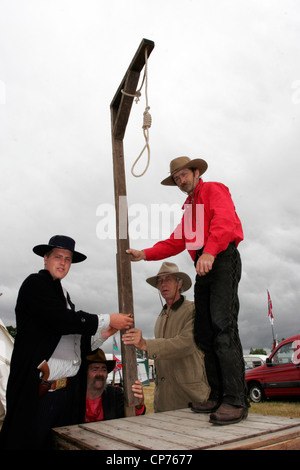 Cowboys erecting a gallows at the Calne Country Music Festival in the Showground, Beversbrook Stock Photo