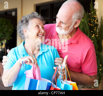 Happily married senior couple on a shopping strip together. Stock Photo