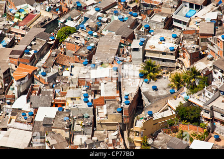 Dwelling conditions Favela do Vidigal Rio de Janeiro Brazil Lots domestic satellite TV receiving dishes & water boxes rooftops Stock Photo