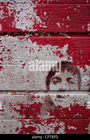 Art on a flaking garage door Stock Photo