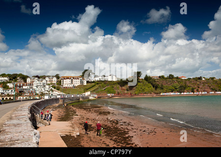 UK, England, Devon, Torquay, Goodrington Sands, visitors on the beach near Roundham Head at high tide Stock Photo