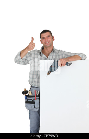 Thumbs up from a builder with a blank board Stock Photo