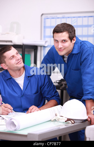 Two factory workers in the office checking stock Stock Photo