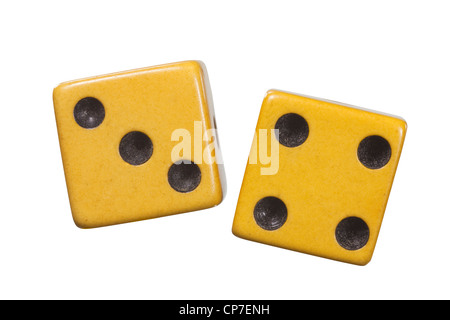 Antique dice with aged yellow patina macro isolated on white. Stock Photo
