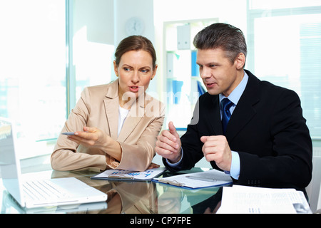 Business partners discussing possible options in terms of a new strategy Stock Photo