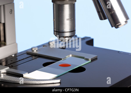 Photo of a laboratory microscope with a blood sample on a glass slide. Stock Photo
