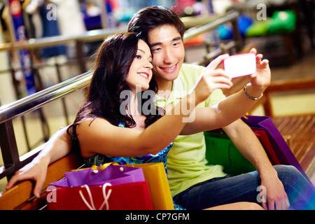 Smiling shoppers taking a picture of themselves Stock Photo